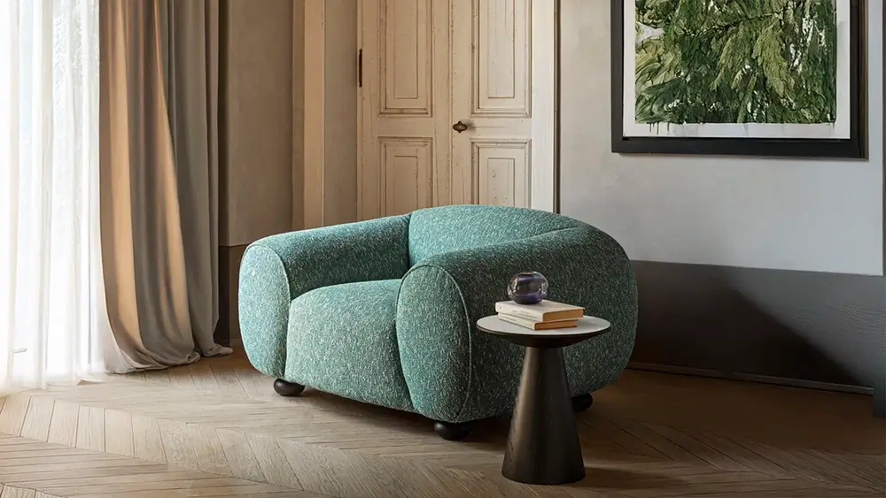 Pier Luigi Frighetto' s Regina armchair is a contemporary piece of furniture that combines generous proportions with sustainable craftsmanship